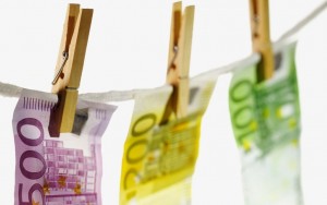 Close-up of various euro notes hanging on clothesline