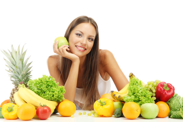 beautiful young woman with fruits and vegetables, isolated on white