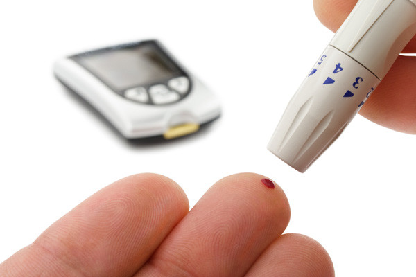 Man performs glucose level blood test isolated